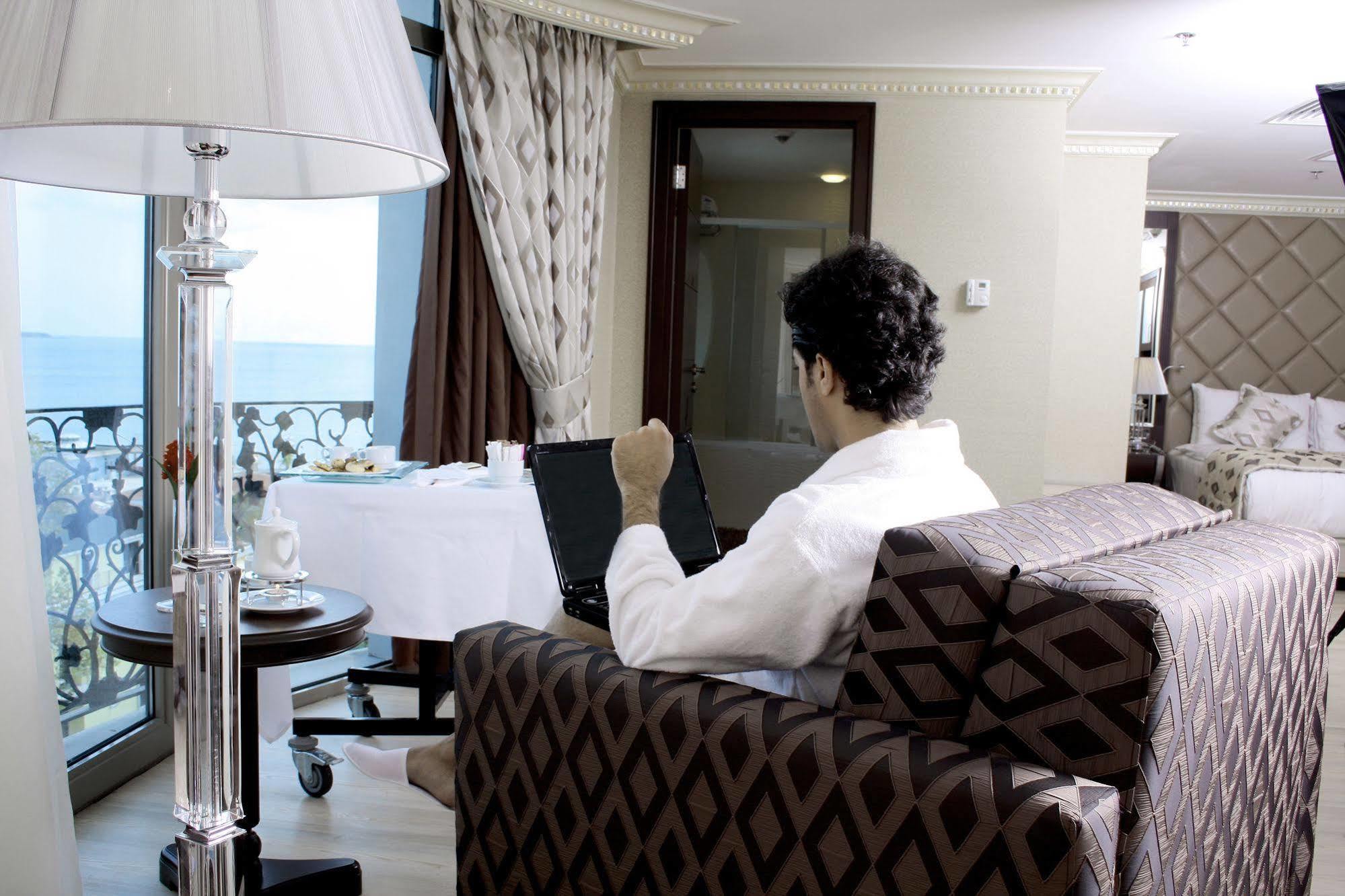 Eser Premium Hotel & Spa Büyükçekmece Exteriör bild A guest using the hotel's Wi-Fi service